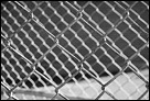 This is a black and white artistic photo of a fense.