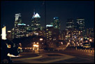 This is a color photo of a night shot of the Philadelphia skyline, standing at the Philly Art Museum, in Pennsylvania.